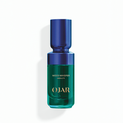 OJAR Wood Whisper Absolute perfume oil in 20ml bottle with blue cap and green body on a white background